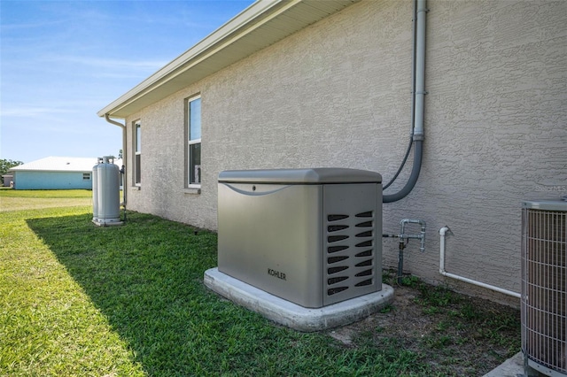 exterior details with a power unit, central AC unit, heating fuel, and stucco siding
