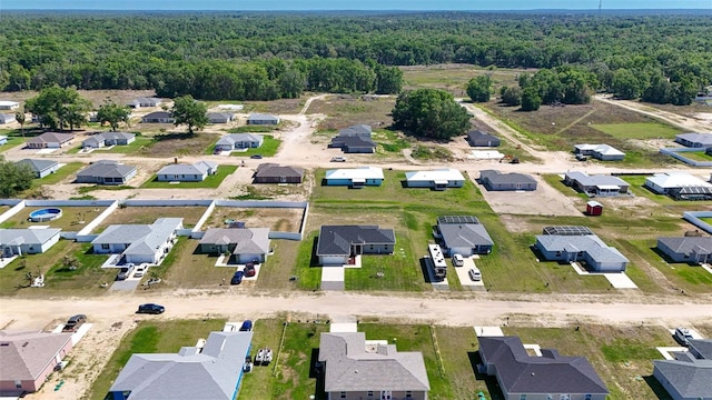 birds eye view of property with a forest view and a residential view