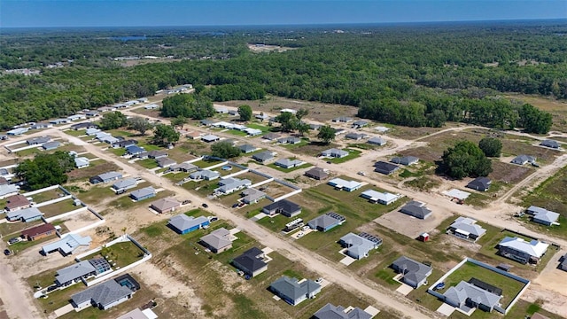 drone / aerial view with a wooded view