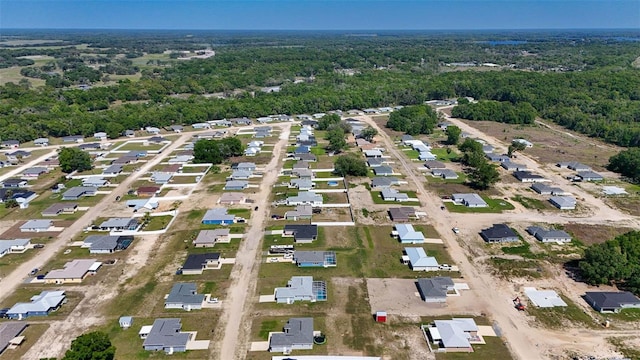 birds eye view of property with a wooded view