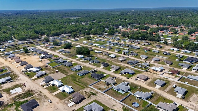 bird's eye view with a wooded view
