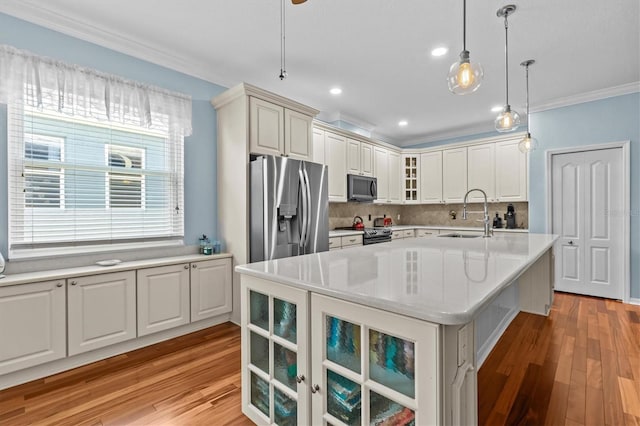 14820 Potterton Cir, Hudson, FL 34667 - kitchen featuring stainless steel appliances, crown molding, light countertops, light wood finished floors, and tasteful backsplash