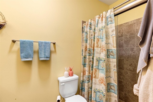 bathroom with tiled shower and toilet