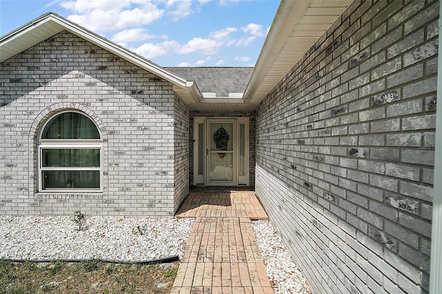 38 Townhill Dr, Eustis, FL 32726 - view of exterior entry with a shingled roof and brick siding