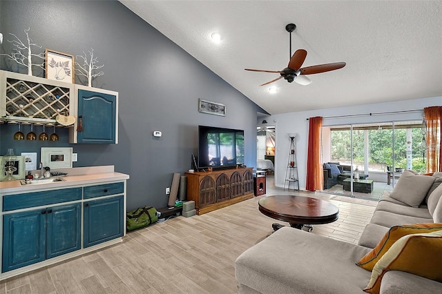 38 Townhill Dr, Eustis, FL 32726 - living area with high vaulted ceiling, ceiling fan, a textured ceiling, and light wood finished floors