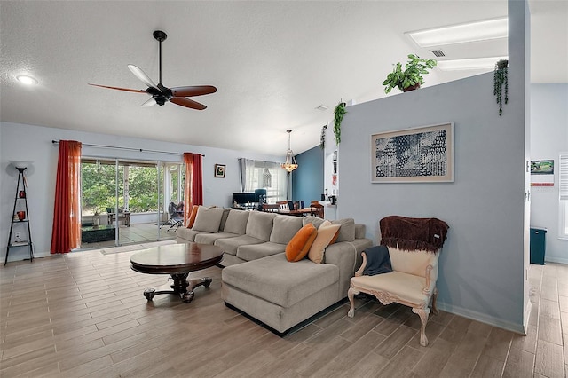 38 Townhill Dr, Eustis, FL 32726 - living area with light wood-style flooring, vaulted ceiling, baseboards, visible vents, and a ceiling fan