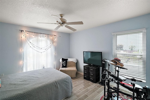 38 Townhill Dr, Eustis, FL 32726 - bedroom with baseboards, a ceiling fan, wood finish floors, and a textured ceiling