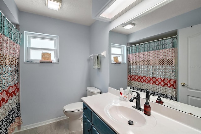 38 Townhill Dr, Eustis, FL 32726 - full bath with a shower with curtain, baseboards, toilet, wood finished floors, and vanity