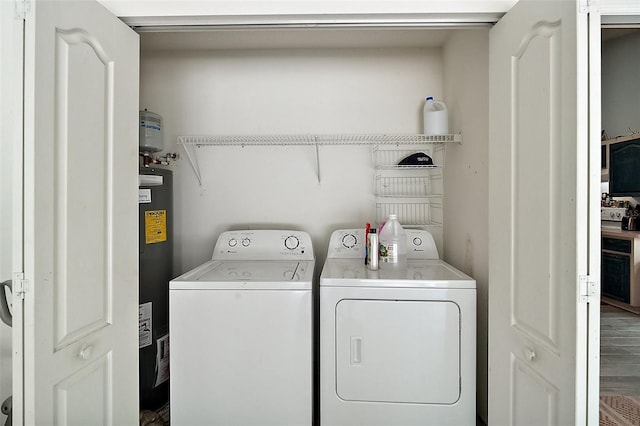 38 Townhill Dr, Eustis, FL 32726 - washroom with washer and dryer, water heater, and laundry area