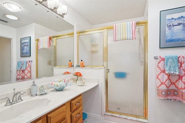 732 Ramirez Ave, The Villages, FL 32159 - full bath with vanity, a shower stall, a textured ceiling, and visible vents