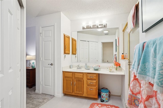 732 Ramirez Ave, The Villages, FL 32159 - full bath featuring vanity, a closet, a textured ceiling, tile patterned floors, and a shower with shower door