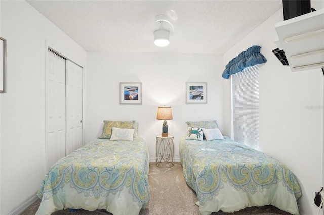 732 Ramirez Ave, The Villages, FL 32159 - carpeted bedroom featuring a textured ceiling, baseboards, and a closet