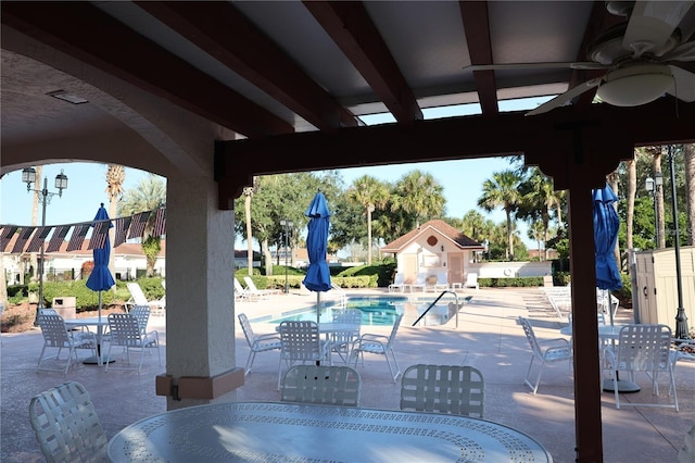 732 Ramirez Ave, The Villages, FL 32159 - community pool with a patio, outdoor dining area, and ceiling fan