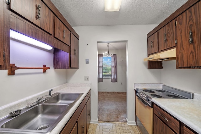 kitchen with electric stove, under cabinet range hood, light countertops, a sink, and a textured ceiling