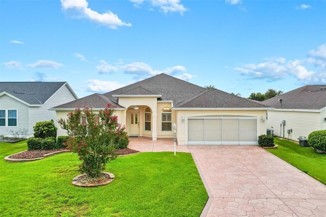 2120 Callaway Dr, The Villages, FL 32162 - single story home featuring an attached garage, concrete driveway, a front lawn, and stucco siding