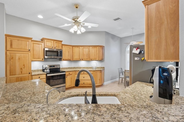 2120 Callaway Dr, The Villages, FL 32162 - kitchen featuring a ceiling fan, light stone counters, appliances with stainless steel finishes, and a sink