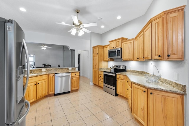 2120 Callaway Dr, The Villages, FL 32162 - kitchen with light tile patterned flooring, a ceiling fan, appliances with stainless steel finishes, and light stone countertops