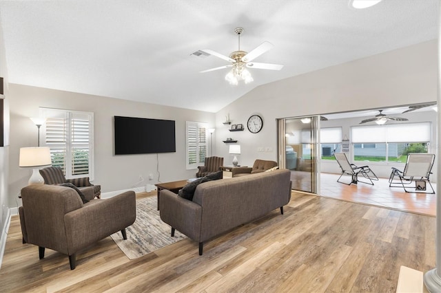 2120 Callaway Dr, The Villages, FL 32162 - living area featuring a ceiling fan, light wood-style flooring, lofted ceiling, and a healthy amount of sunlight