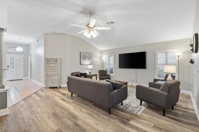 2120 Callaway Dr, The Villages, FL 32162 - living room featuring lofted ceiling, light wood-style flooring, visible vents, ceiling fan, and baseboards