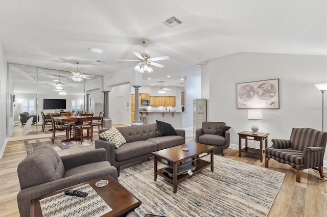 2120 Callaway Dr, The Villages, FL 32162 - living area with light wood-style flooring, decorative columns, ceiling fan, baseboards, and visible vents