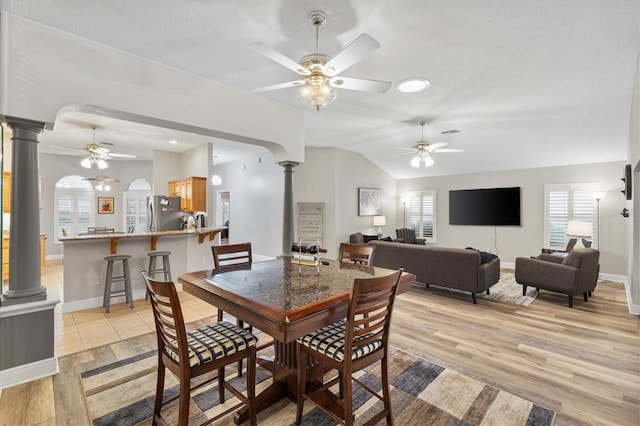 2120 Callaway Dr, The Villages, FL 32162 - dining space featuring vaulted ceiling, ceiling fan, decorative columns, and light wood-style floors