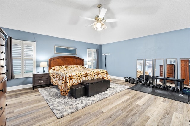 2120 Callaway Dr, The Villages, FL 32162 - bedroom featuring baseboards, wood finished floors, a ceiling fan, and vaulted ceiling