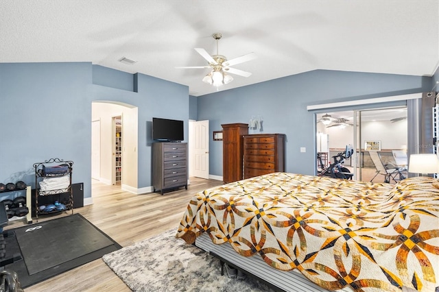 2120 Callaway Dr, The Villages, FL 32162 - bedroom featuring lofted ceiling, baseboards, arched walkways, light wood finished floors, and a ceiling fan