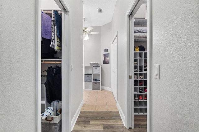 2120 Callaway Dr, The Villages, FL 32162 - spacious closet with visible vents, wood finished floors, and a ceiling fan