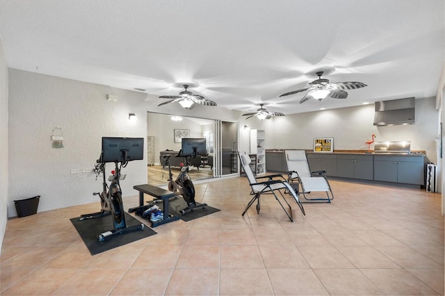 2120 Callaway Dr, The Villages, FL 32162 - exercise room with light tile patterned floors, ceiling fan, and a textured wall