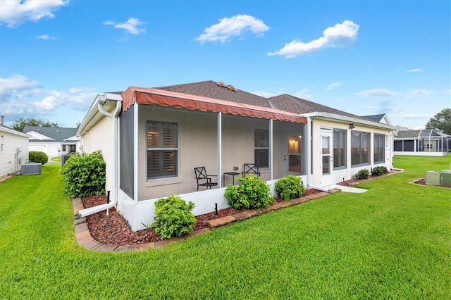 2120 Callaway Dr, The Villages, FL 32162 - rear view of house featuring a yard, central AC unit, and a sunroom
