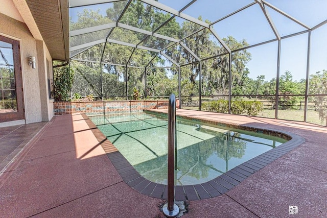 outdoor pool featuring a patio area and glass enclosure