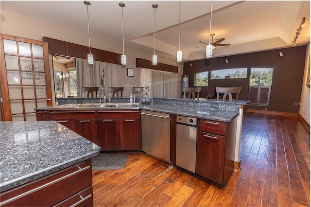 kitchen with decorative light fixtures, a ceiling fan, and dark wood-type flooring