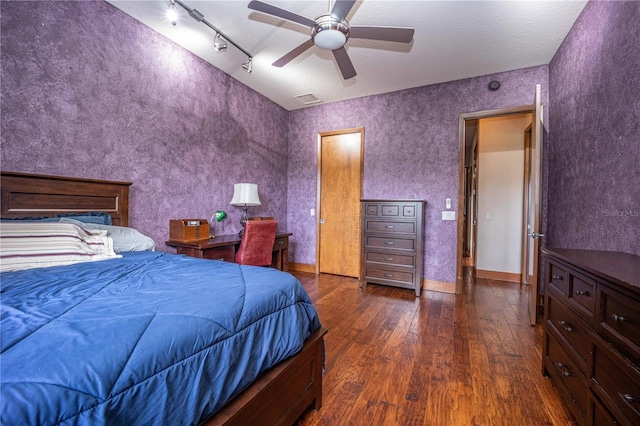 bedroom with visible vents, a textured ceiling, ceiling fan, and wood-type flooring