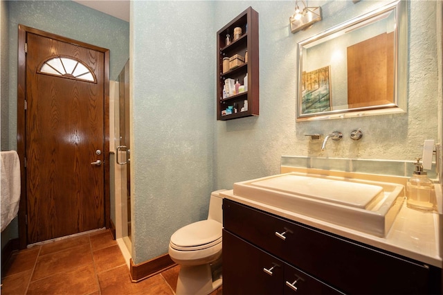 bathroom featuring a shower stall, tile patterned floors, vanity, a textured wall, and toilet