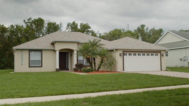 13546 Biscayne Grove Ln, Grand Island, FL 32735 - ranch-style house featuring an attached garage, driveway, stucco siding, and a front yard