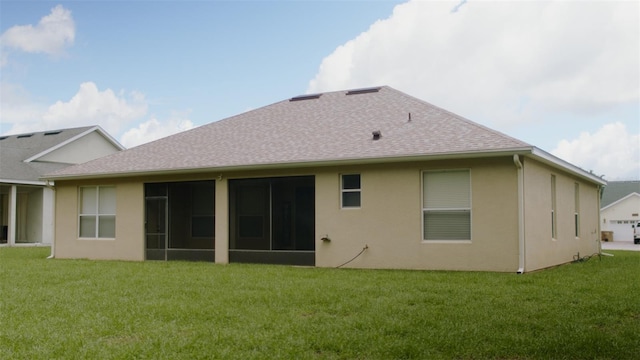 13546 Biscayne Grove Ln, Grand Island, FL 32735 - back of house featuring roof with shingles, a lawn, stucco siding, and a sunroom