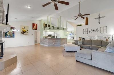 living room with high vaulted ceiling, ceiling fan, and a multi sided fireplace