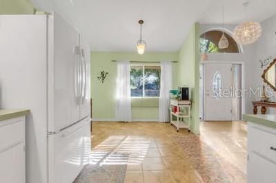 foyer entrance with lofted ceiling and light tile patterned floors