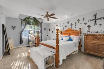 bedroom featuring a ceiling fan, baseboards, and light carpet