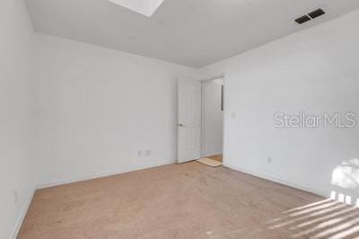 spare room with visible vents and carpet