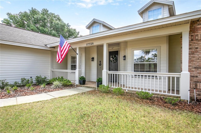 17728 Palm View Cir, Mount Dora, FL 32757 - view of front of home featuring covered porch and a front yard
