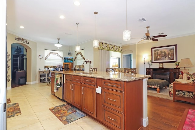 kitchen with a wealth of natural light, visible vents, a sink, and crown molding