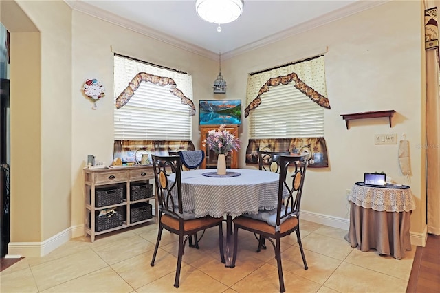 dining room with baseboards, crown molding, and light tile patterned flooring