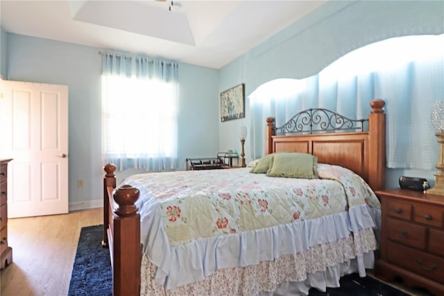 bedroom with baseboards and wood finished floors