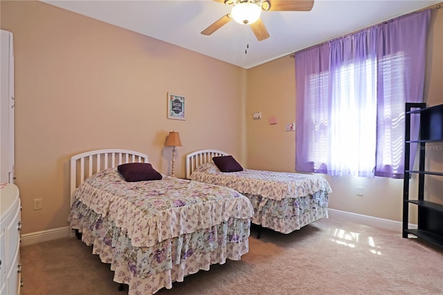 bedroom featuring ceiling fan, carpet floors, and baseboards