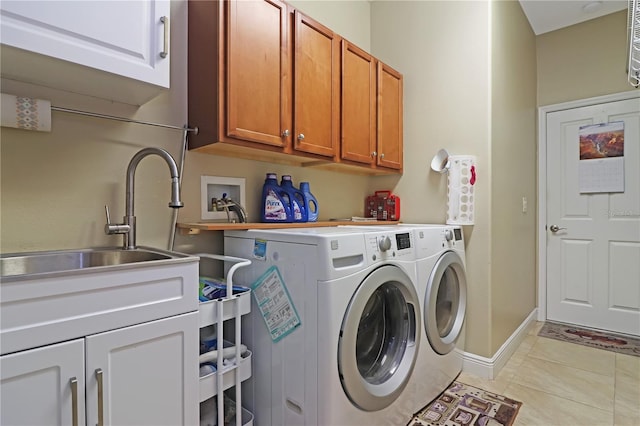 washroom featuring washer and clothes dryer, a sink, light tile patterned floors, cabinet space, and baseboards