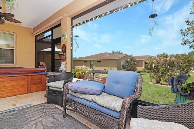 view of patio with a ceiling fan and a hot tub