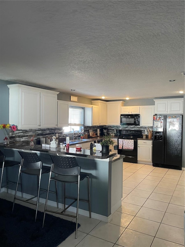 879 Little Bend Rd, Altamonte Springs, FL 32714 - kitchen with black appliances, dark countertops, a peninsula, backsplash, and light tile patterned floors