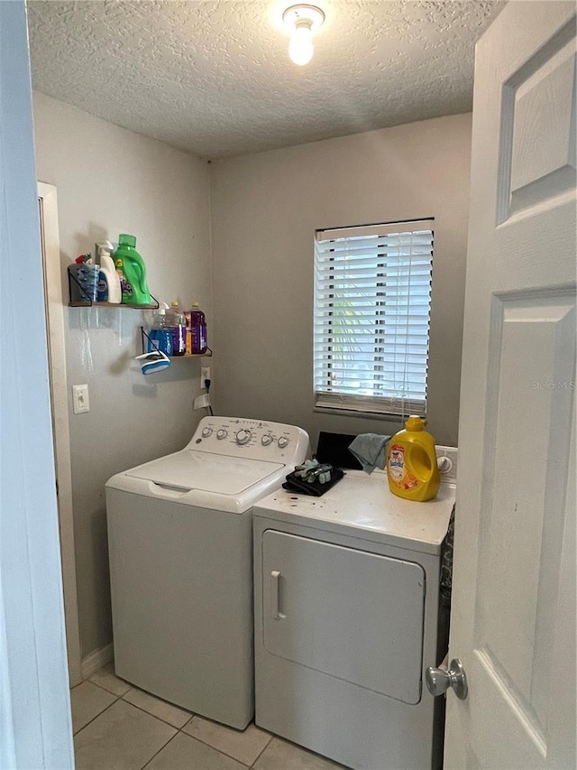879 Little Bend Rd, Altamonte Springs, FL 32714 - laundry room featuring washer and dryer, light tile patterned floors, and a textured ceiling