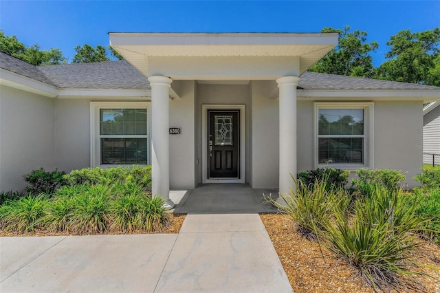 16380 SE 84th Ct, Summerfield, FL 34491 - property entrance with a shingled roof and stucco siding